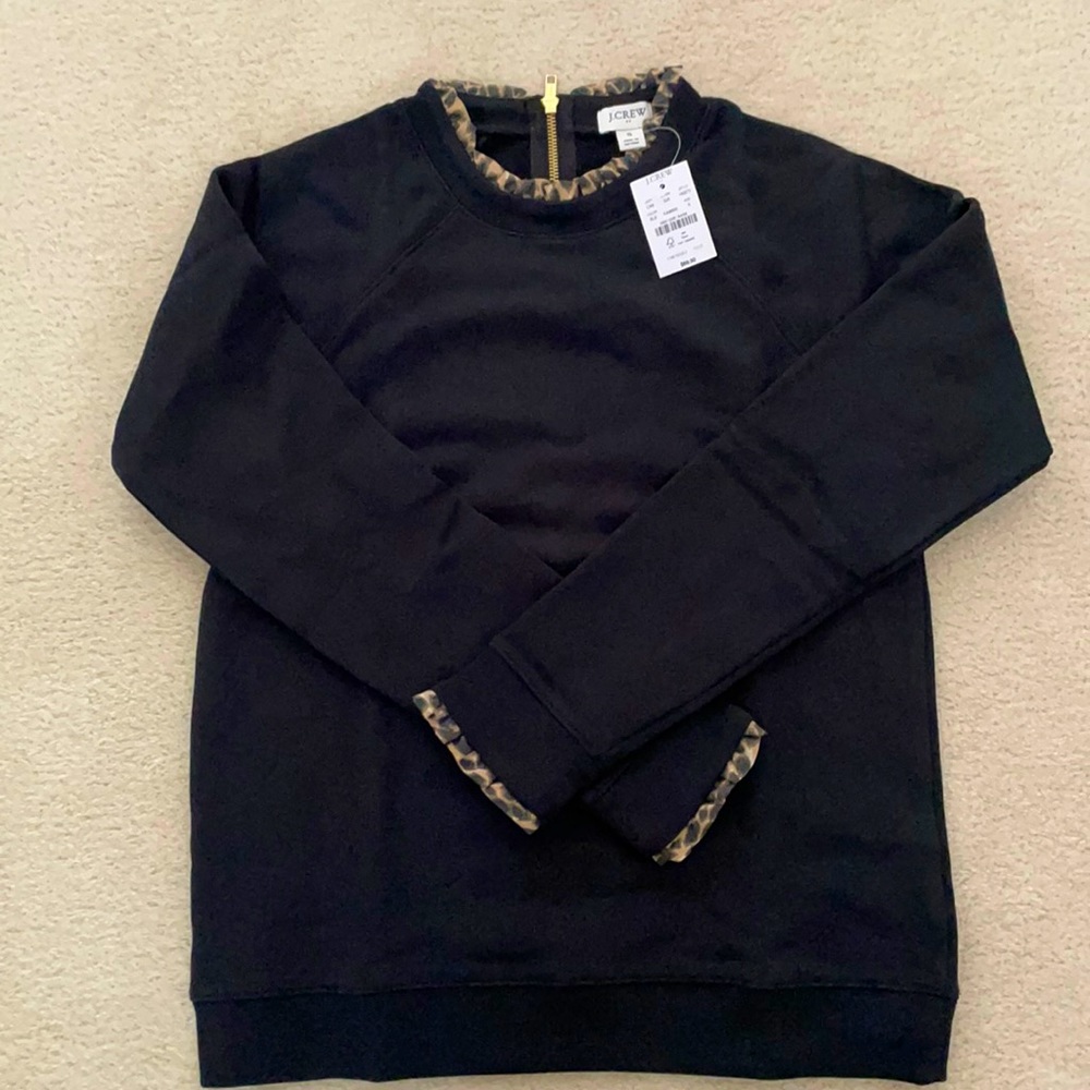 J Crew black top with animal print ruffles